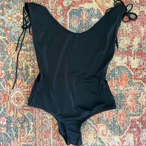 Blackmilk one piece with low back and open sides. Size M